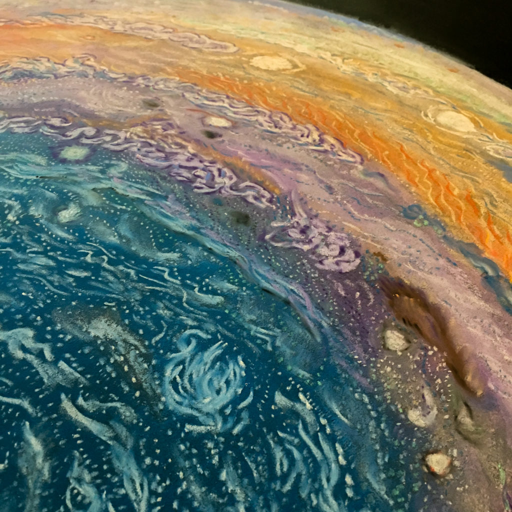 "Falling" is composed of pastel on a black sheet of wood. It is 6ft tall and 2ft wide. Most of the painting is black with a few scattered stars. Immense planets are found at the ends of the scene. A small purple and gold craft falls away from Earth at the top of the painting and down toward an equally miniscule target: 16-Psyche. This asteroid sits at the center of the painting, floating between Jupiter and Mars.