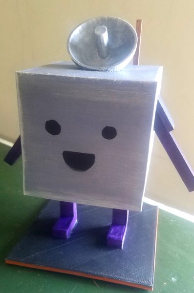 A square silver cube figure with purple rectangular arms and rectangular body stands on a table looking out a window. It has a satellite dish as a hat and wears a bronze painted cube backpack. There is a lens flare casting light into the room onto the figure's face as it looks at a tree in the distance.