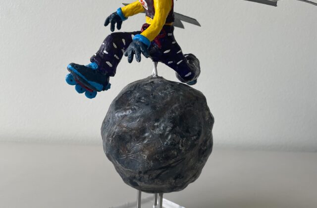A clay sculpture of a skater girl, reimagining NASA’s Psyche spacecraft. She soars mid-air over the 16 Psyche asteroid, her rollerblades powered by hall thrusters. Sunglasses mimic solar cells, and sleek wings extend from her back. Painted in Psyche mission colors, the piece blends science and art, capturing the excitement of space exploration.